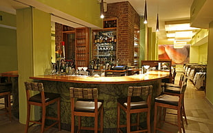 brown wooden bar with chairs and table